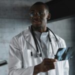 man in white lab gown wearing eyeglasses