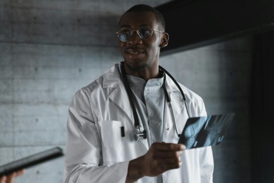 man in white lab gown wearing eyeglasses